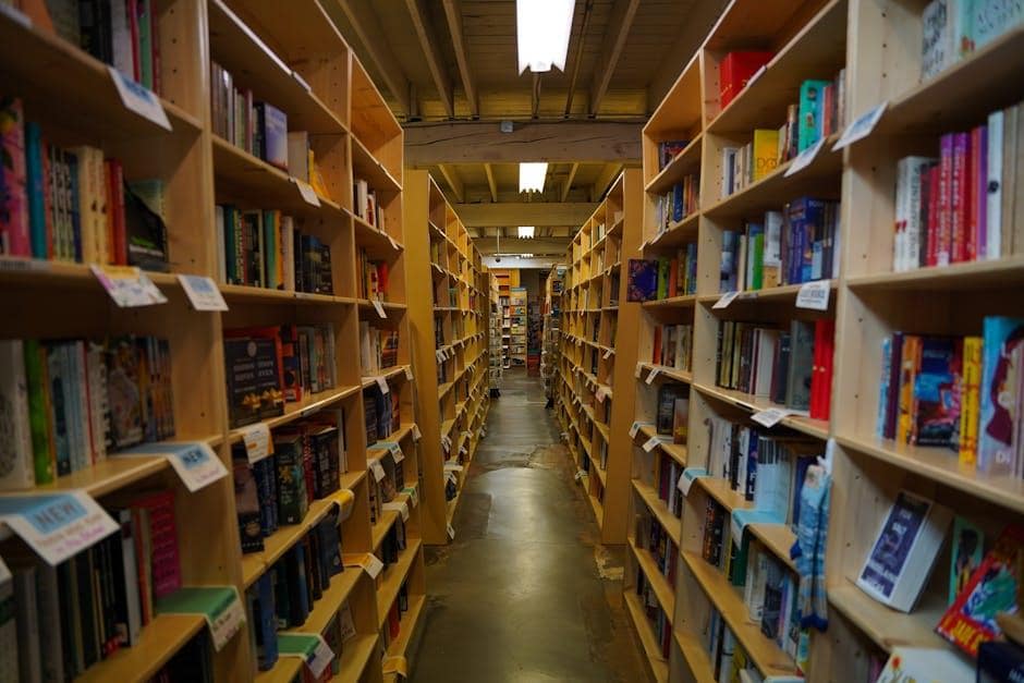 Explore a cozy bookstore aisle filled with books in Portland, Oregon. Perfect for book lovers.